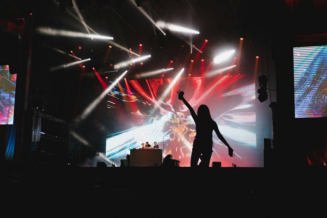 Person dancing with arms raised at a concert.